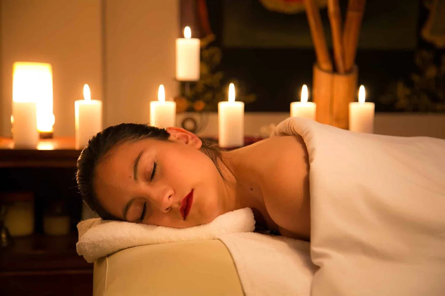 Guest resting by candlelight after a treatment — representative image